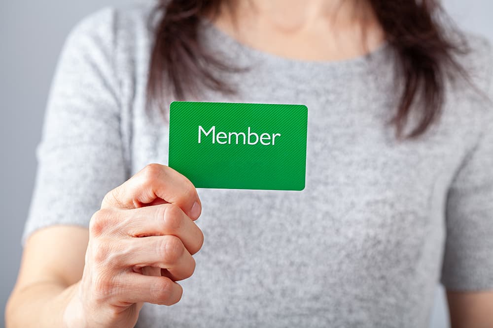 Woman holding membership card